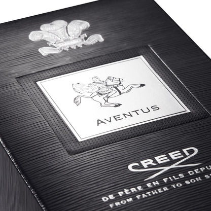Close-up of a Creed Aventus perfume box with branding and design details. The Style Hub